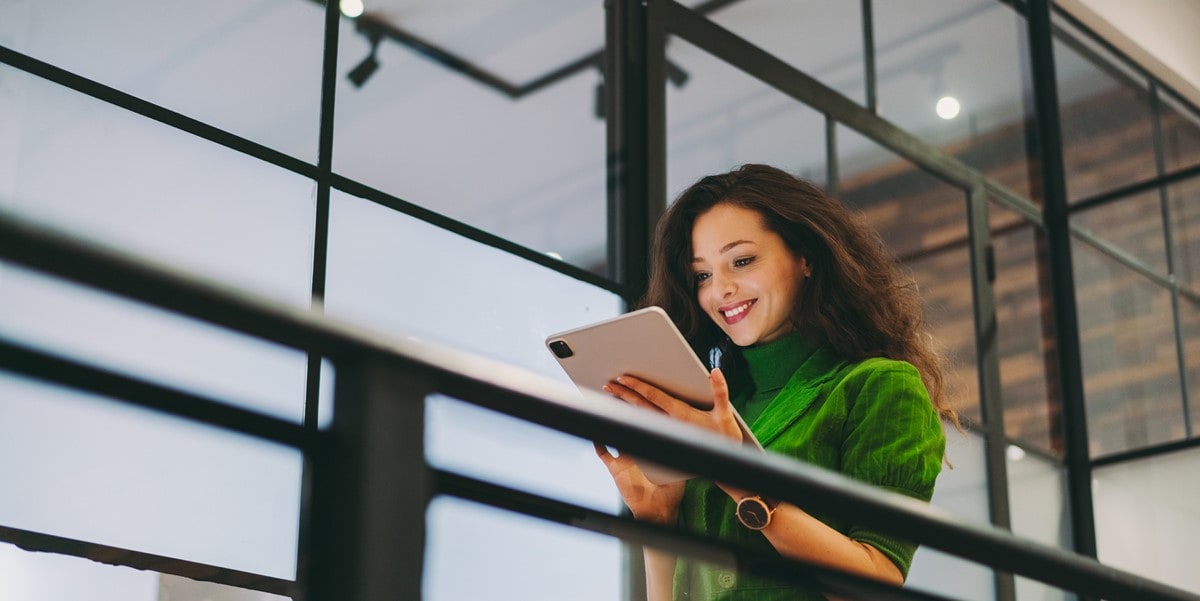 woman in office looking at tablet