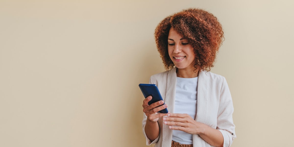 professional woman looking at her phone in hand