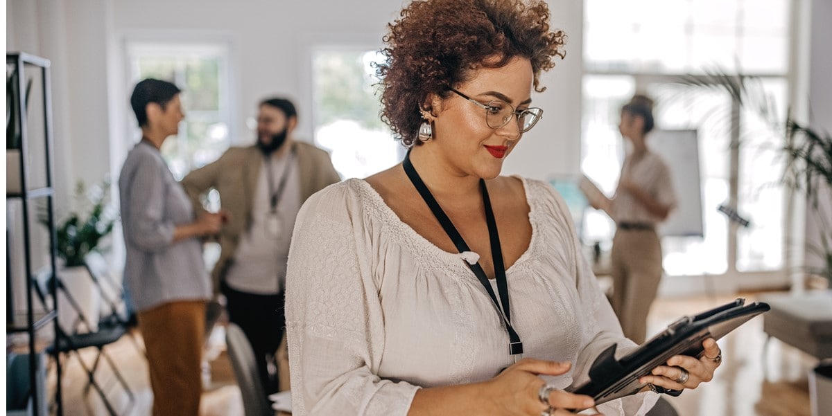 professional woman in office looking at tablet